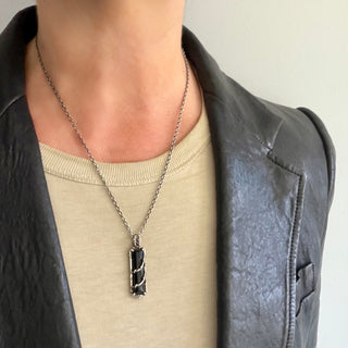 Karen Karch Silver Vine Entwined Elongated merald Cut Onyx Amulet on a  person.