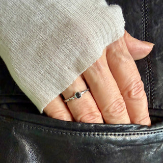 Karen Karch Silver Vine Stacker with a bezel-set brilliant cut black diamond on a hand.