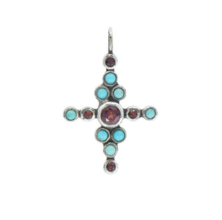 Karen Karch Star-crossed silver Cross amulet pendant created from clus\tered beel set turquoise and red sapphires on a white background.