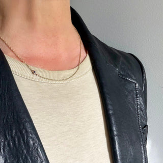 Karen Karch Yellow Gold Chain Necklace with Rose Gold Star With Black Diamond Center on neck