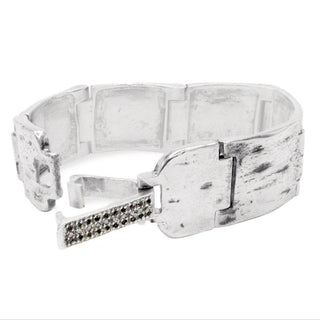 A 20mm wide weathered silver Mainstay Bracelet with a studded clasp featuring black and white diamonds, shown open, designed by Karen Karch.