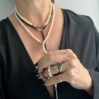 A white freshwater pearl and silver lariat with a weathered texture closure styled by Karen Karch
