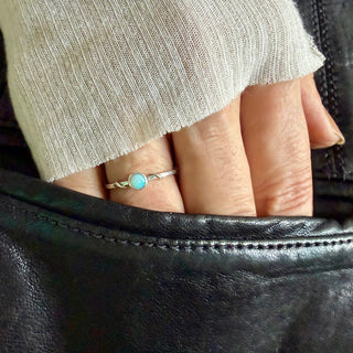 Karen Karch Silver Vine Stacker Ring with a 3.5 mm opal on a hand.