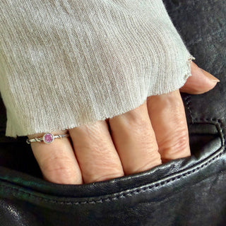 Karen Karch Silver Vine Stacker with a bezel-set pink sapphire on a hand.