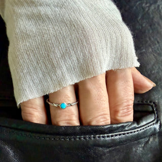 Karen Karch Silver Vine Stacker Ring with bezel set turquoise on a hand. 