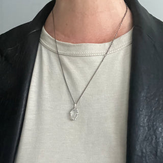Person wearing a Karen Karch by Deme Wolfe Sterling Silver Clear Coffin Shape Crystal on a white background