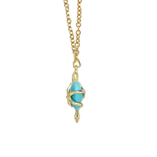 Karen Karch by Deme Wolfe Side View of Serpentine Love Turquoise Heart embraced by a 10k yellow gold snake on a gold filled chain on a white background.
