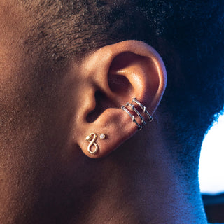 Karen Karch by Deme Wolfe Sterling Silver Infinity Shape Snake Studs on man's ear styled with triple vine ear cuff