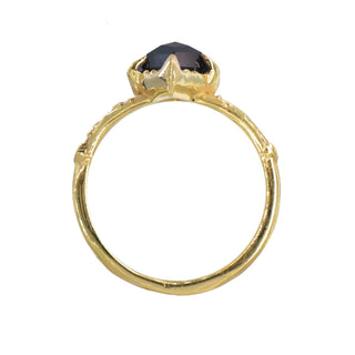 Karen Karch by Deme Wolfe diamond-shaped black onyx gemstone set in a chiseled 14k yellow gold band ring, top view, on white background.