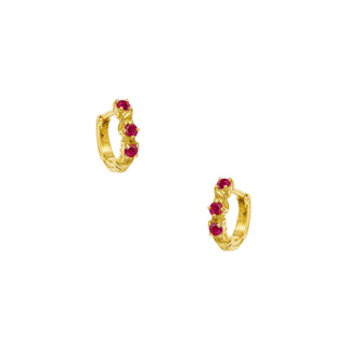 Karen Karch Yellow Gold huggie hoop earrings with rubies on a white background.
