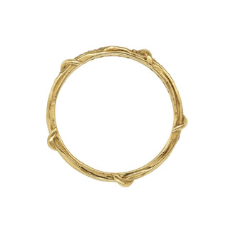 A weathered band in 18k yellow gold is detailed with organic twining vines is studded with colorless brilliant cut diamonds on the top half, top view,  shown on a white background.