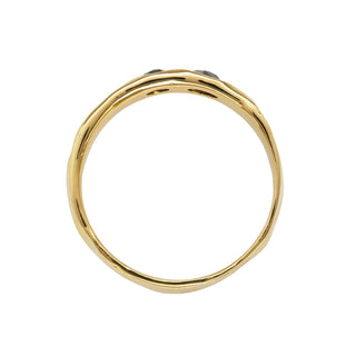 A Karen Karch 18k Gold unisex band with two rose-cut black diamonds of different sizes sunken into the surface, top view, on a white background.