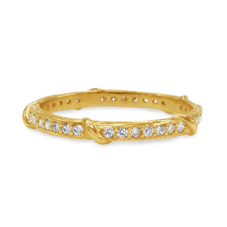 Karen Karch 18k yellow gold diamond Eternity band with crossing vine details on white background.