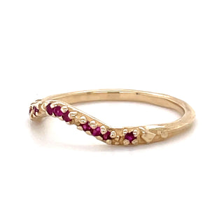 A Karen Karch by Deme Wolfe 14k yellow gold ring with rubies on the front of a curved band on a white background, 3/4 view.