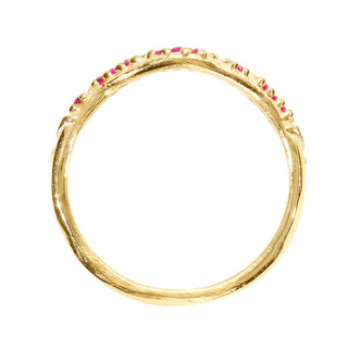 A Karen Karch by Deme Wolfe 14k yellow gold ring with rubies on the front of a curved band, top view, on a white background. 