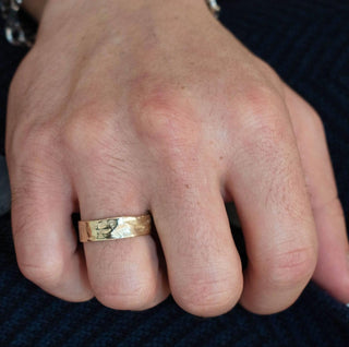 Karen Karch Everpresent Weathered Irregular edge 14k yellow gold 7.5 mm band on man's hand.
