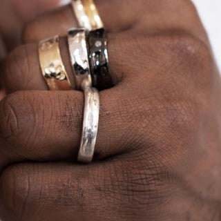 Karen Karch History Weathered Irregular edge platinum 4mm band on hand styled with other bands.