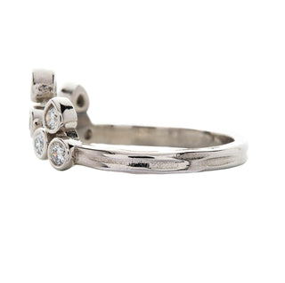 Karen Karch Turned Out Belgian Tiara Curved Ring in platinu mwith 10 brilliant cut colorless diamonds in a crown like formation, side view, on white background.