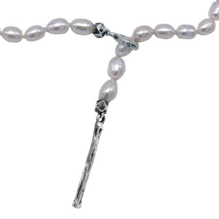 A white freshwater pearl and silver lariat close up of weathered texture closure by Karen Karch