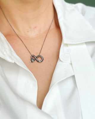 Karen Karch by Deme Wolfe Silver Snake Slide with Moonstone charm on chain on person in white shirt 